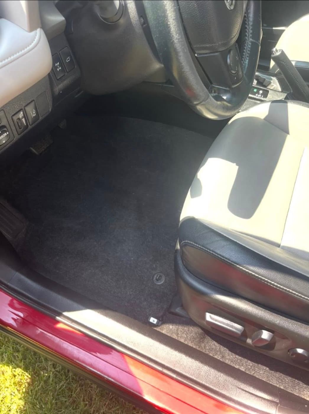Same driver-side floor after vacuum and hot-water extraction — carpet clean