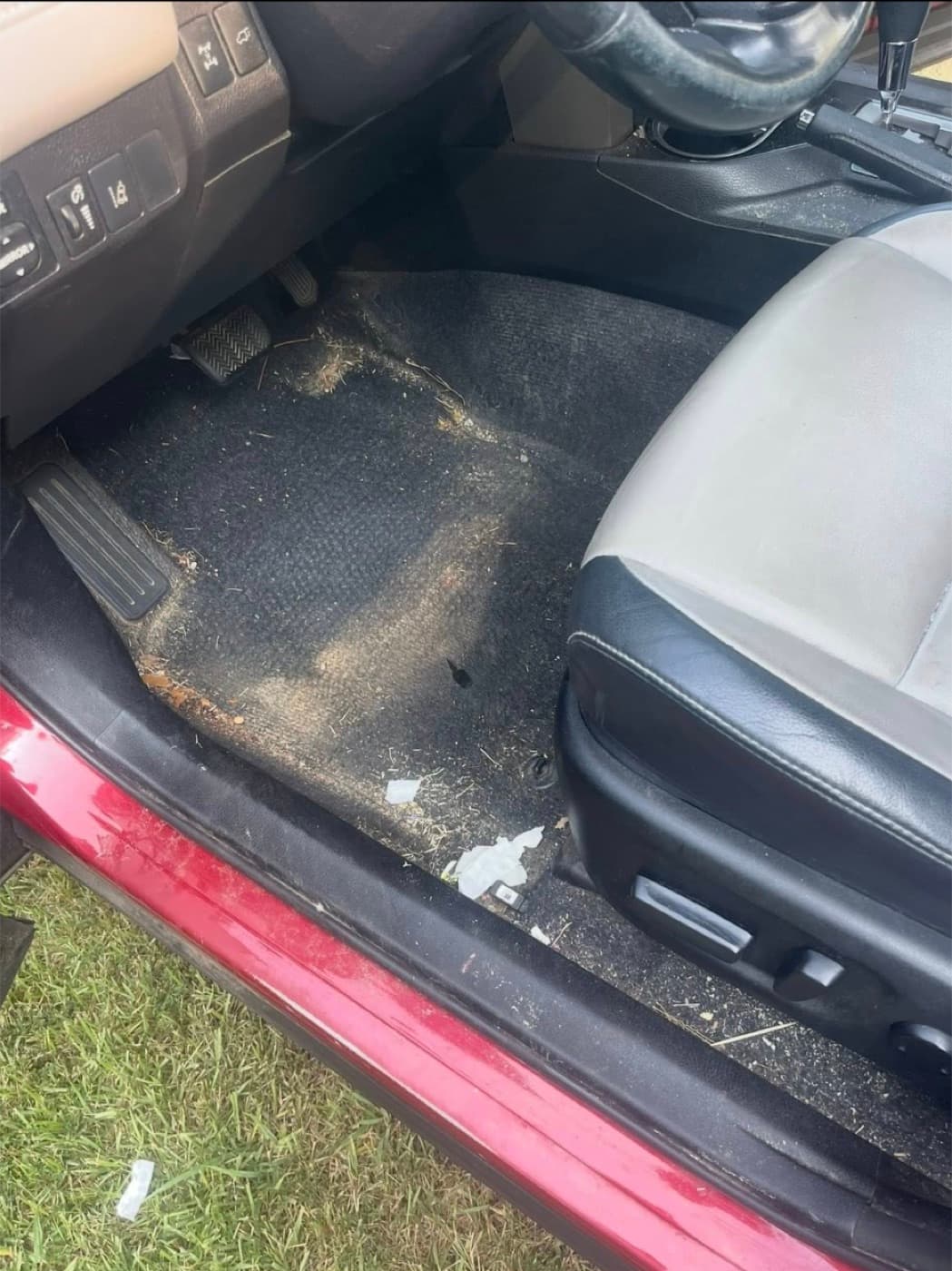 Driver-side floor mat before — sand, crumbs and dried debris